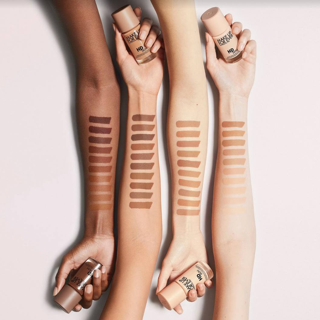 Four arms ranging from dark to light swatched with HD Skin foundation shades