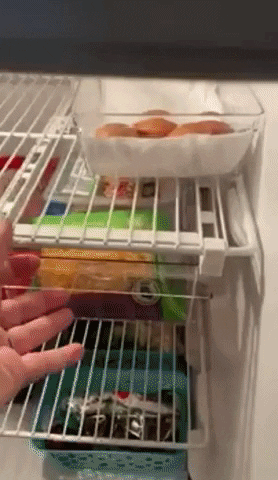 a reviewer opening the drawer in the fridge
