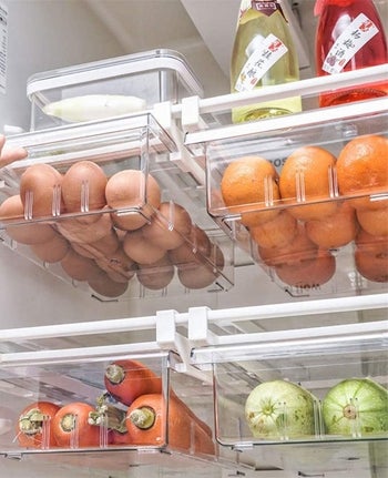 four drawers attached to fridge shelves to hold eggs and other veggies