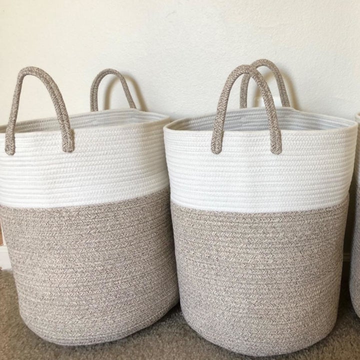 a reviewer photo of two tall woven baskets with handles