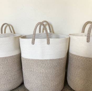 a reviewer photo of two tall woven baskets with handles