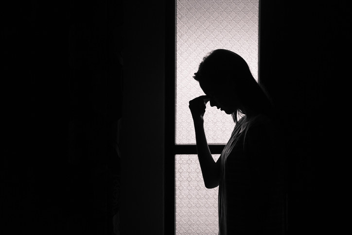 silhouette of an upset woman