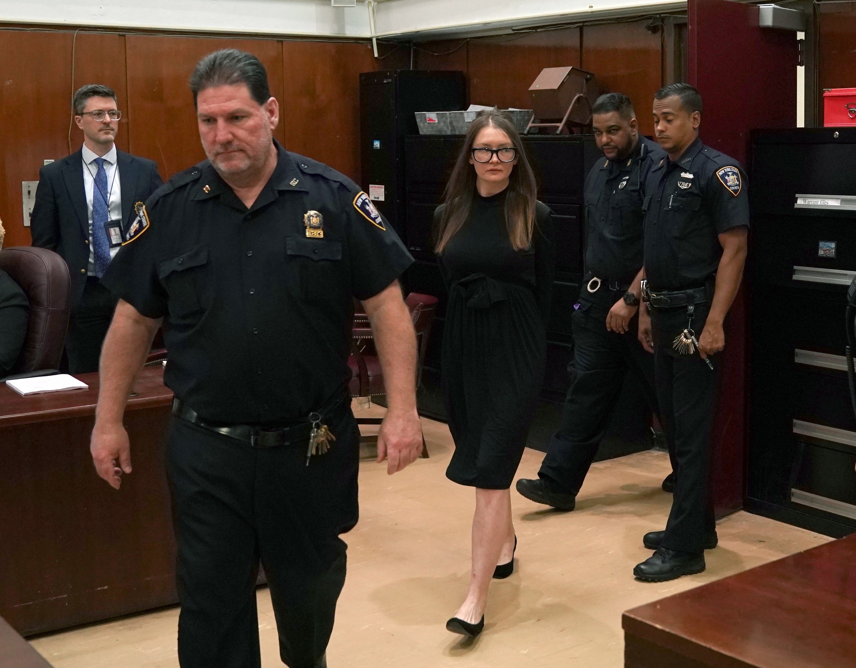 Anna being escorted into the court