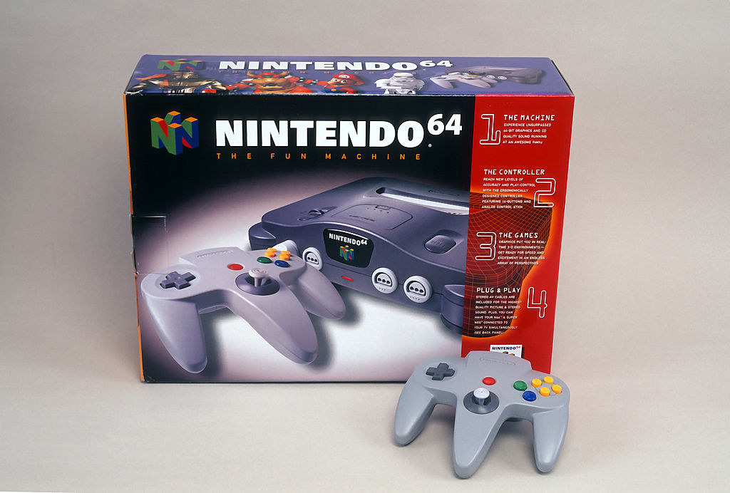 A boxed Nintendo 64 with controller by the packaging