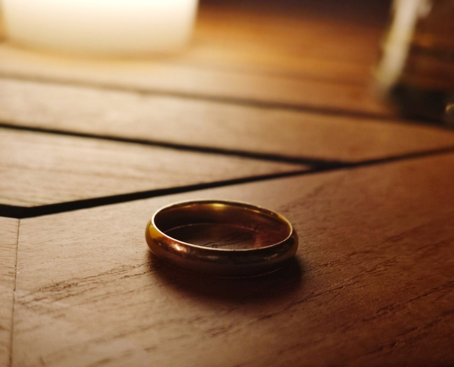 Idle wedding ring on wood nightstand