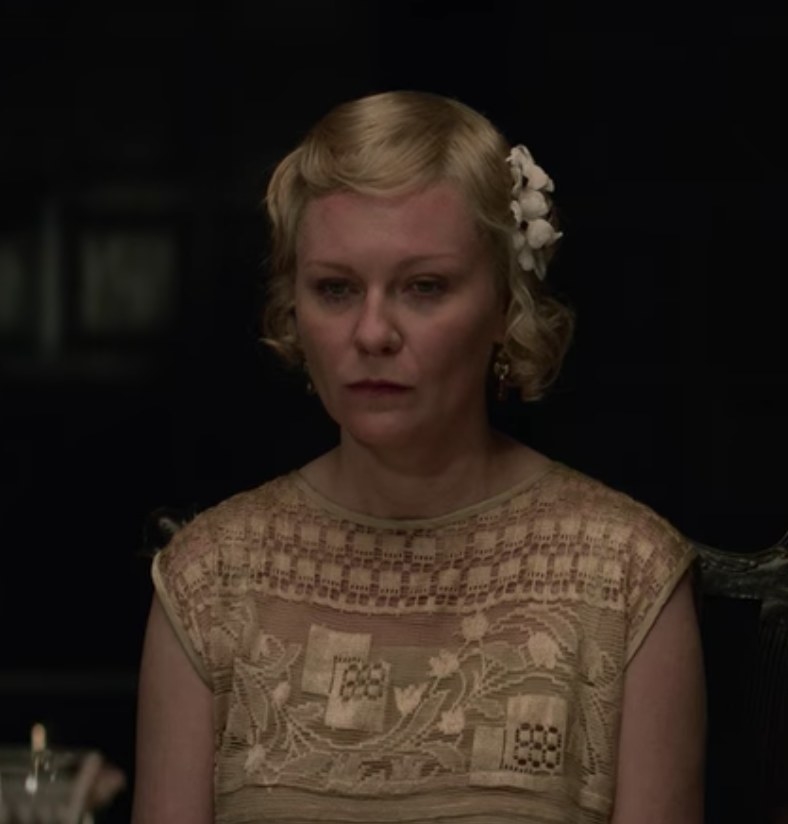 Kirsten Dunst as Rose sits at the dinner table