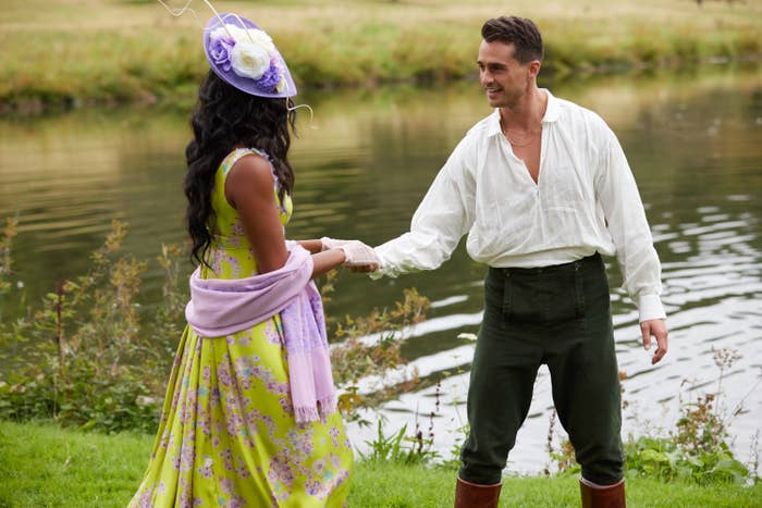 A gentleman extending his hand to a woman