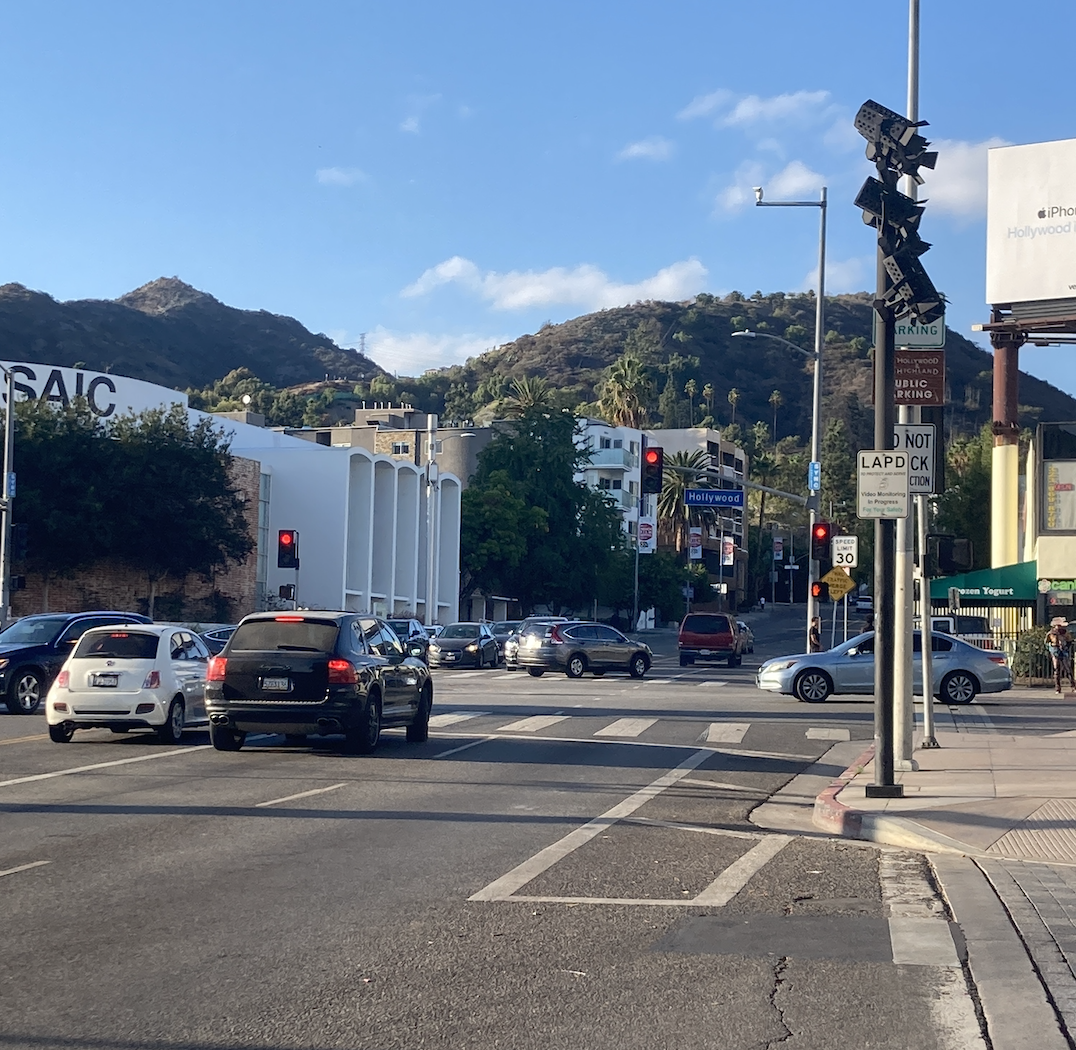 Cars driving towards Hollywood Blvd with hills in the background