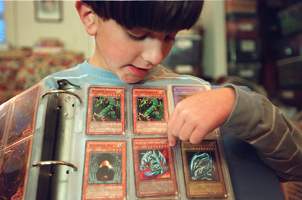 Kid showing off his  Yu-Gi-Oh cards