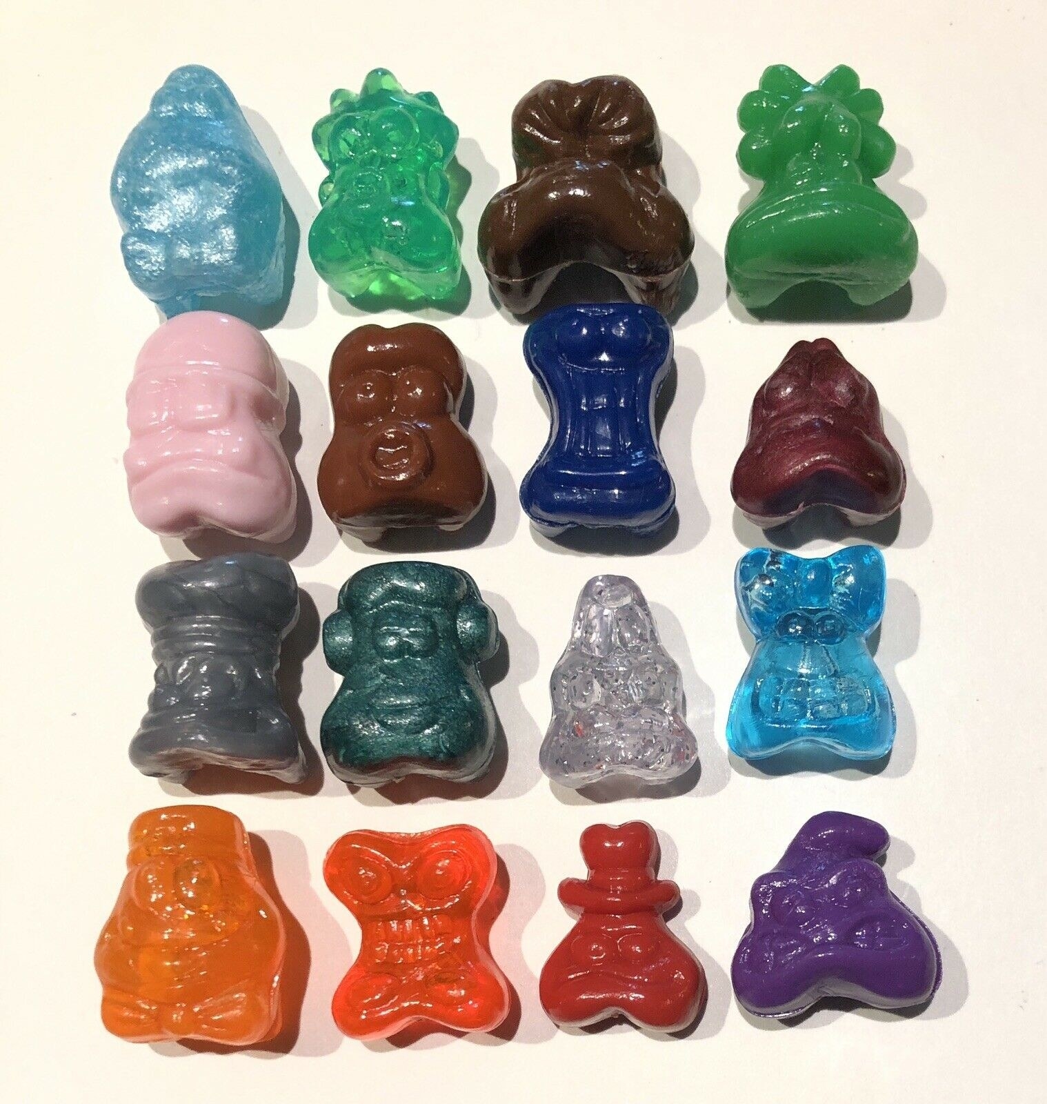 16 Gogo's Crazy Bones displayed on white table top