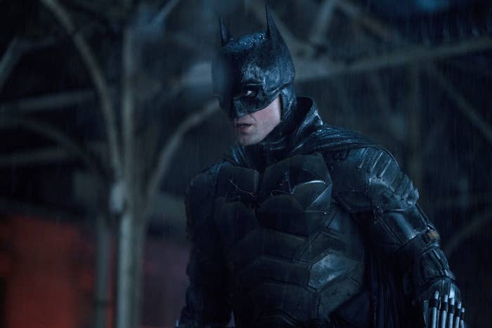 Batman stands in the rain in the film