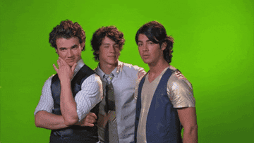 The Jonas Brothers posing with their hands under their chins