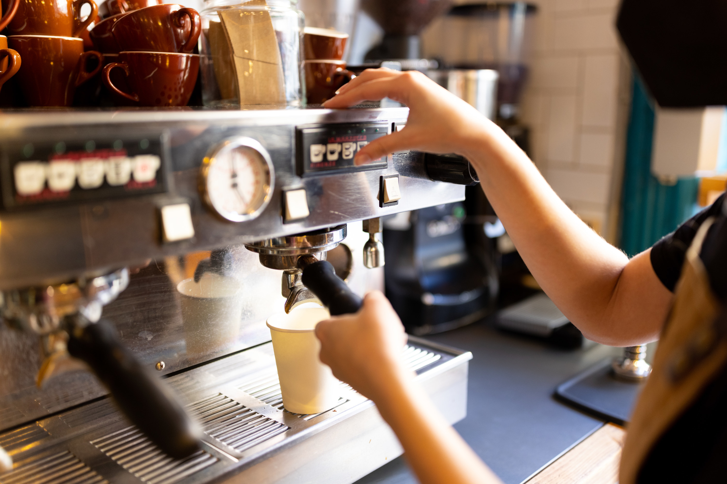 A barista making coffee in a cafe