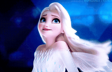 A close up of Princess Elsa as she smiles and looks up at the sky