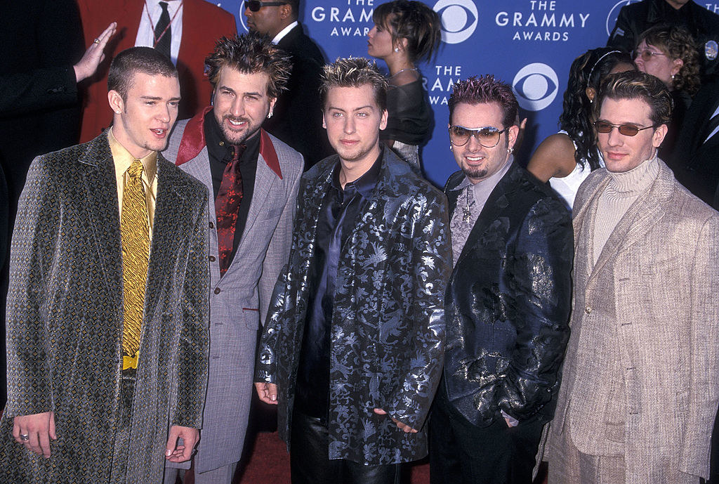 NSYNC is wearing long coats that resemble trench coats