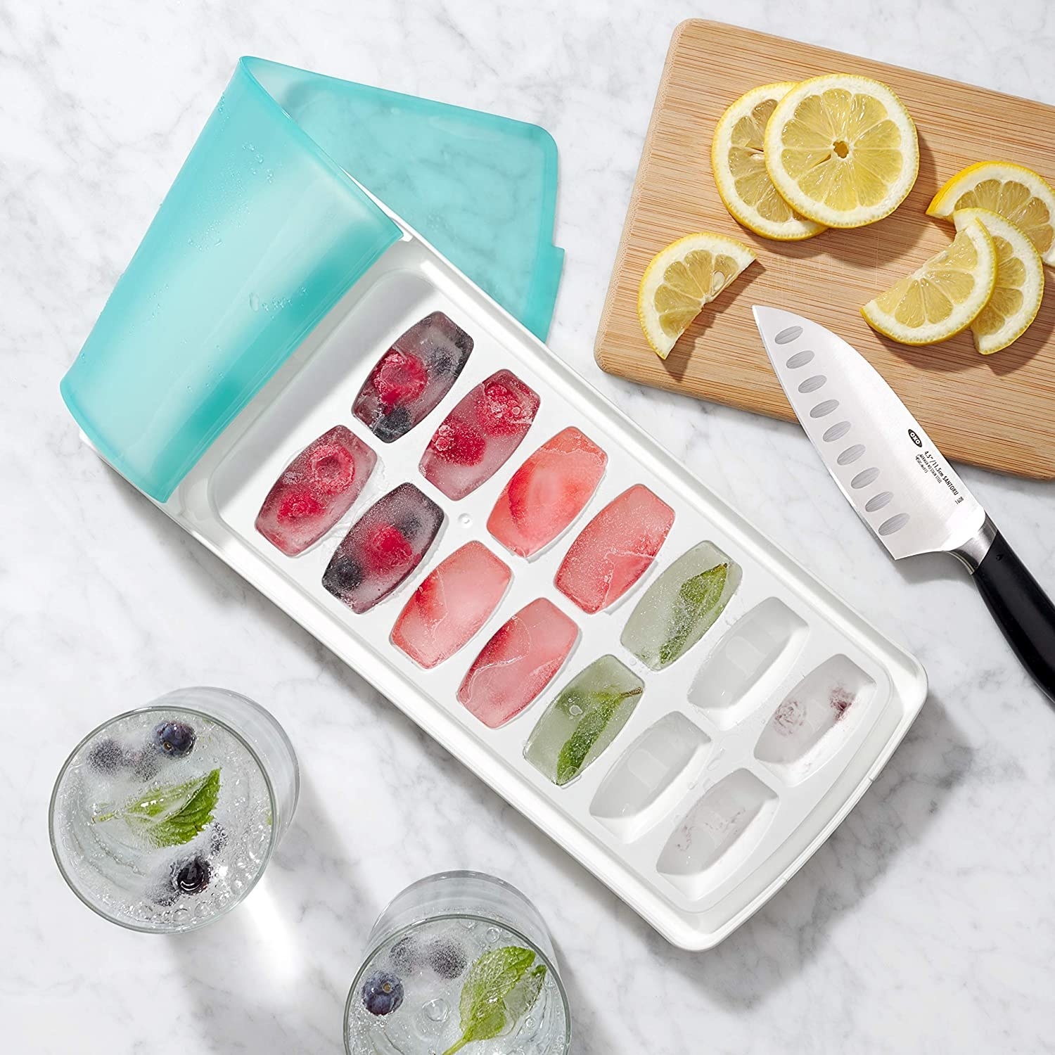 the ice tray with the flexible silicone lid peeled back to show the cubes