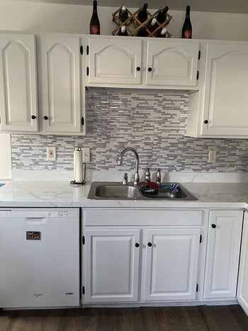 same kitchen with white painted cabinets after