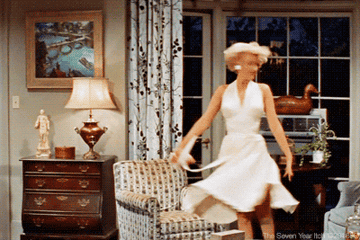 GIF of Marilyn Monroe spinning in a white dress in the movie &quot;The Seven Year Itch&quot;