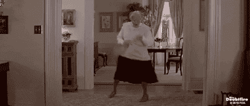 A gif of Mrs. Doubtfire playing air guitar with a broomstick