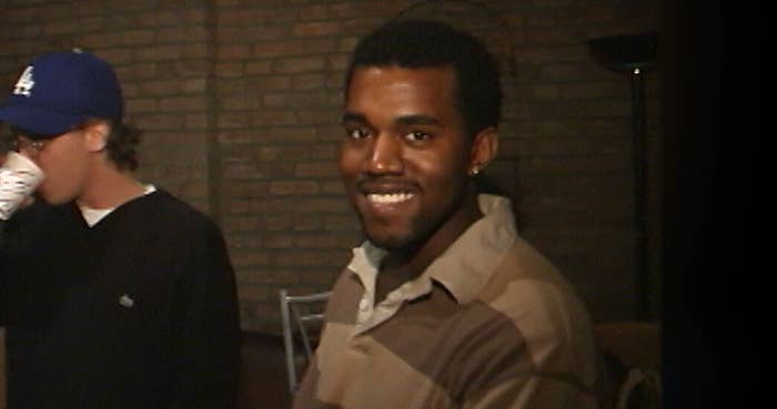 A young Kanye West smiling to camera