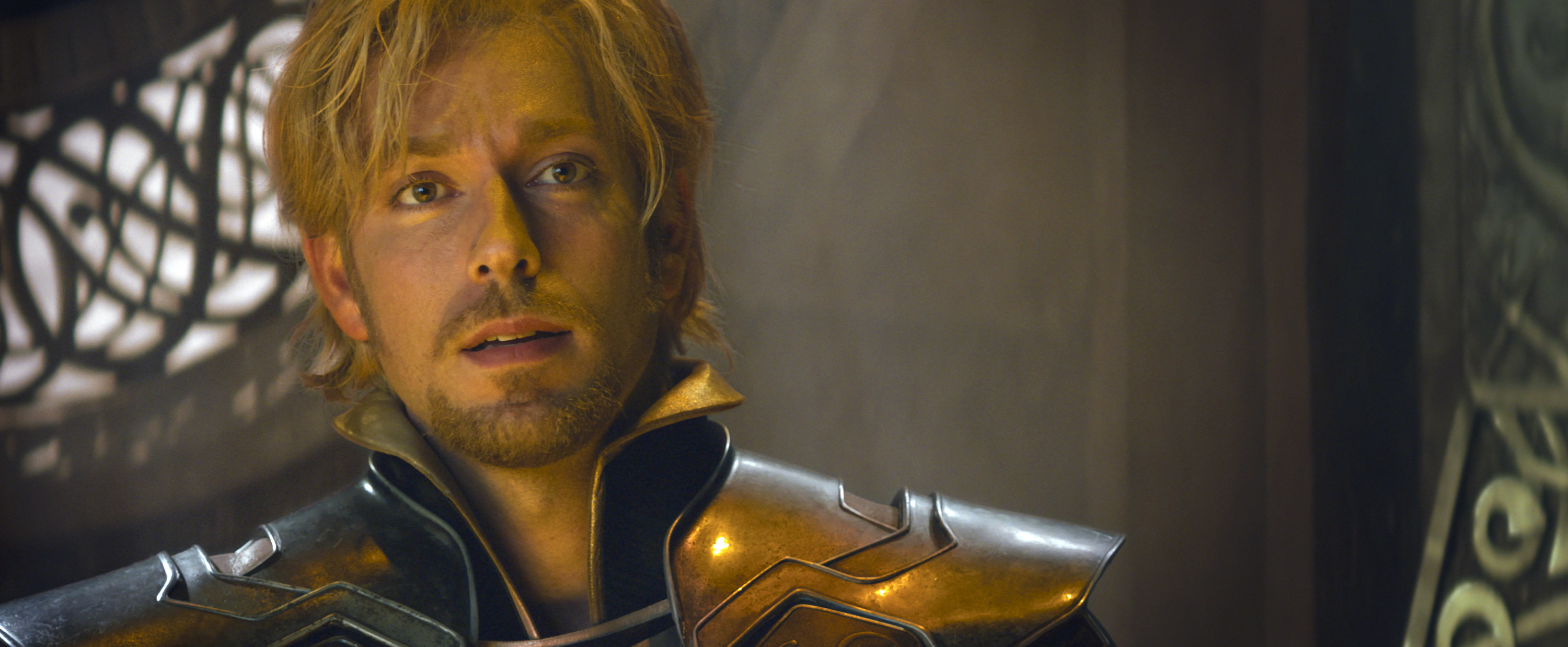 dressed in shiny armor, Fandral gives a pitiful look