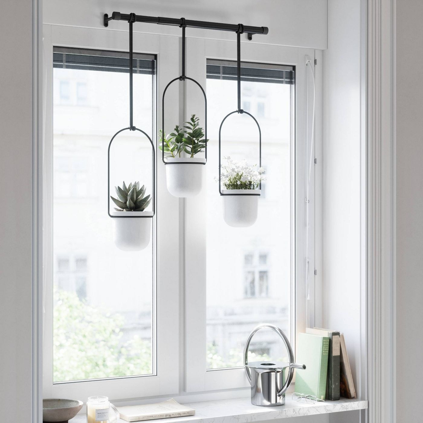 A set of three black and white hanging planters