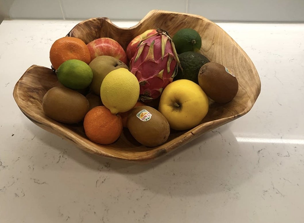 Reviewer&#x27;s photo of the wooden bowl holding fruit