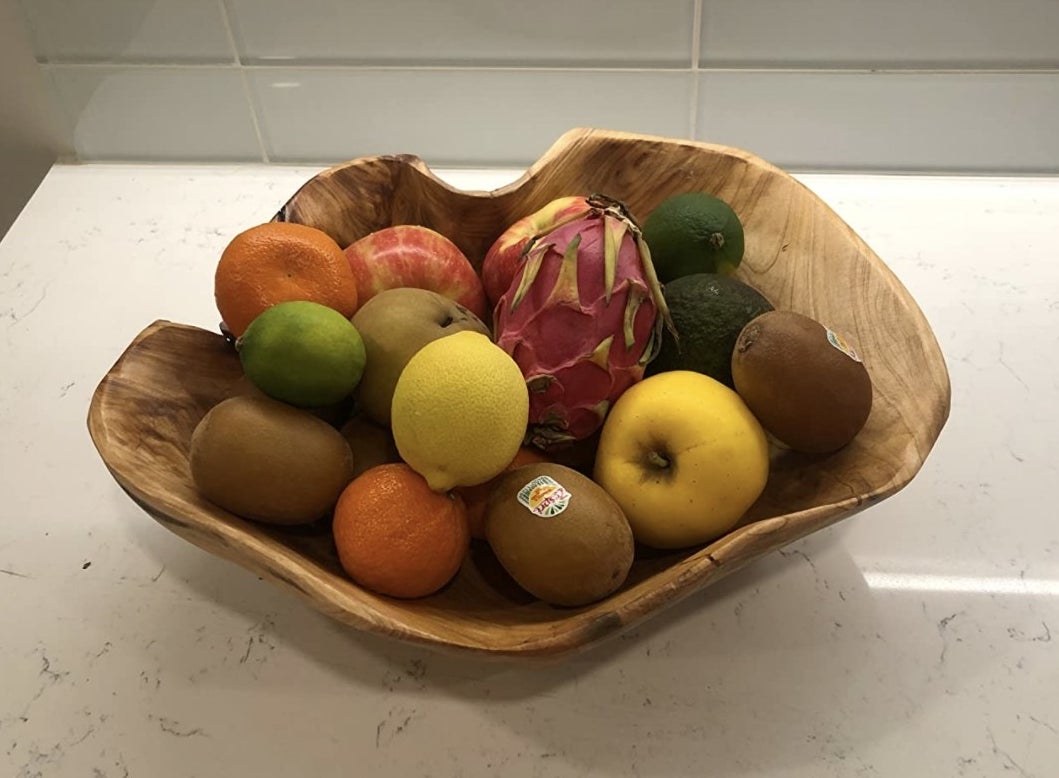 Reviewer&#x27;s photo of the wooden bowl holding fruit