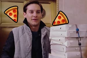 Toby McGuire stands by a box of pizza boxes