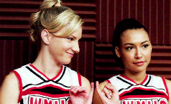 Brittany and Santana linking pinkies before Santana leans on Brittany&#x27;s shoulder on &quot;Glee&quot;
