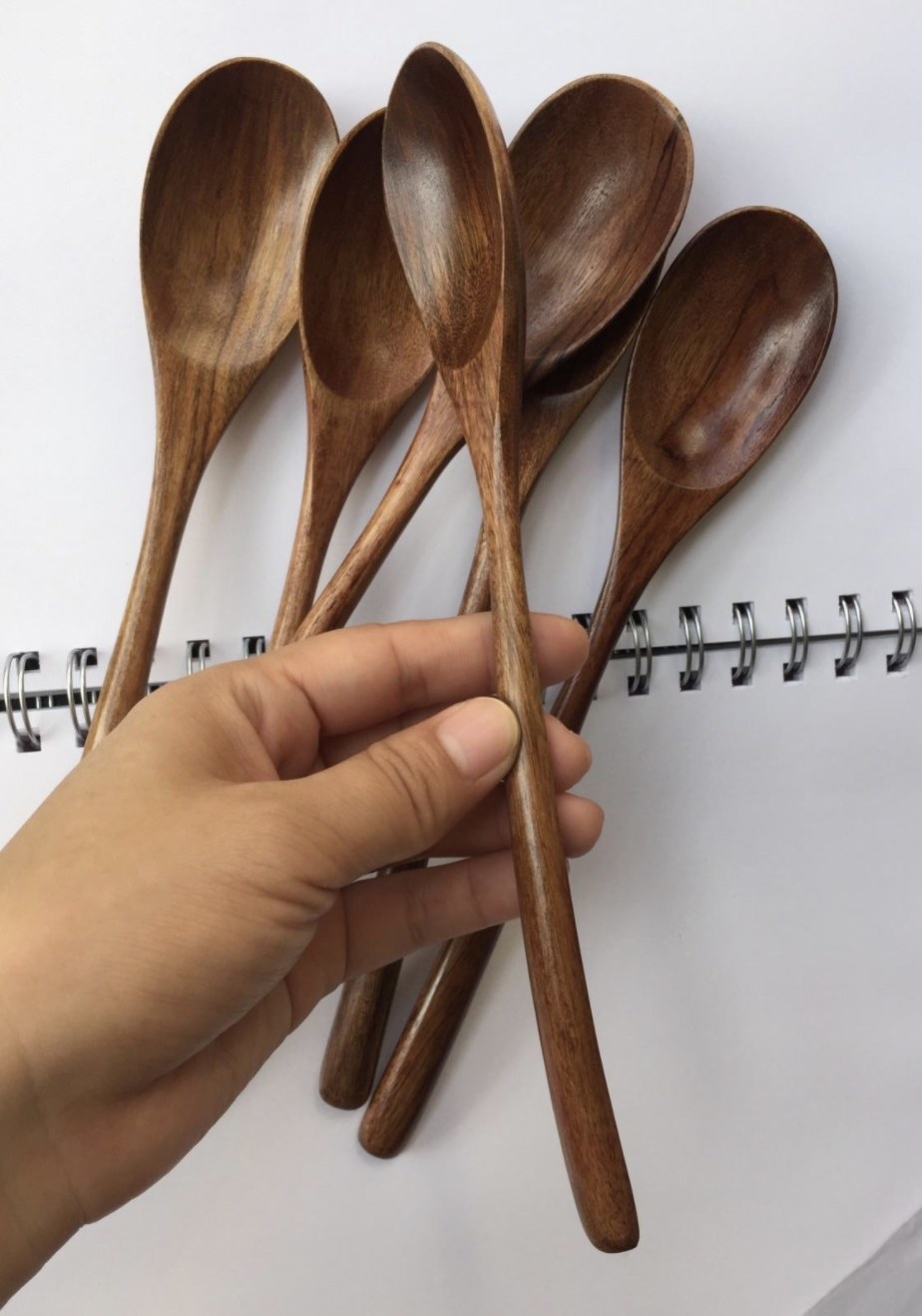 a person holding one of the spoons