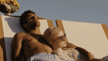 A man and a woman lounging on beach chairs