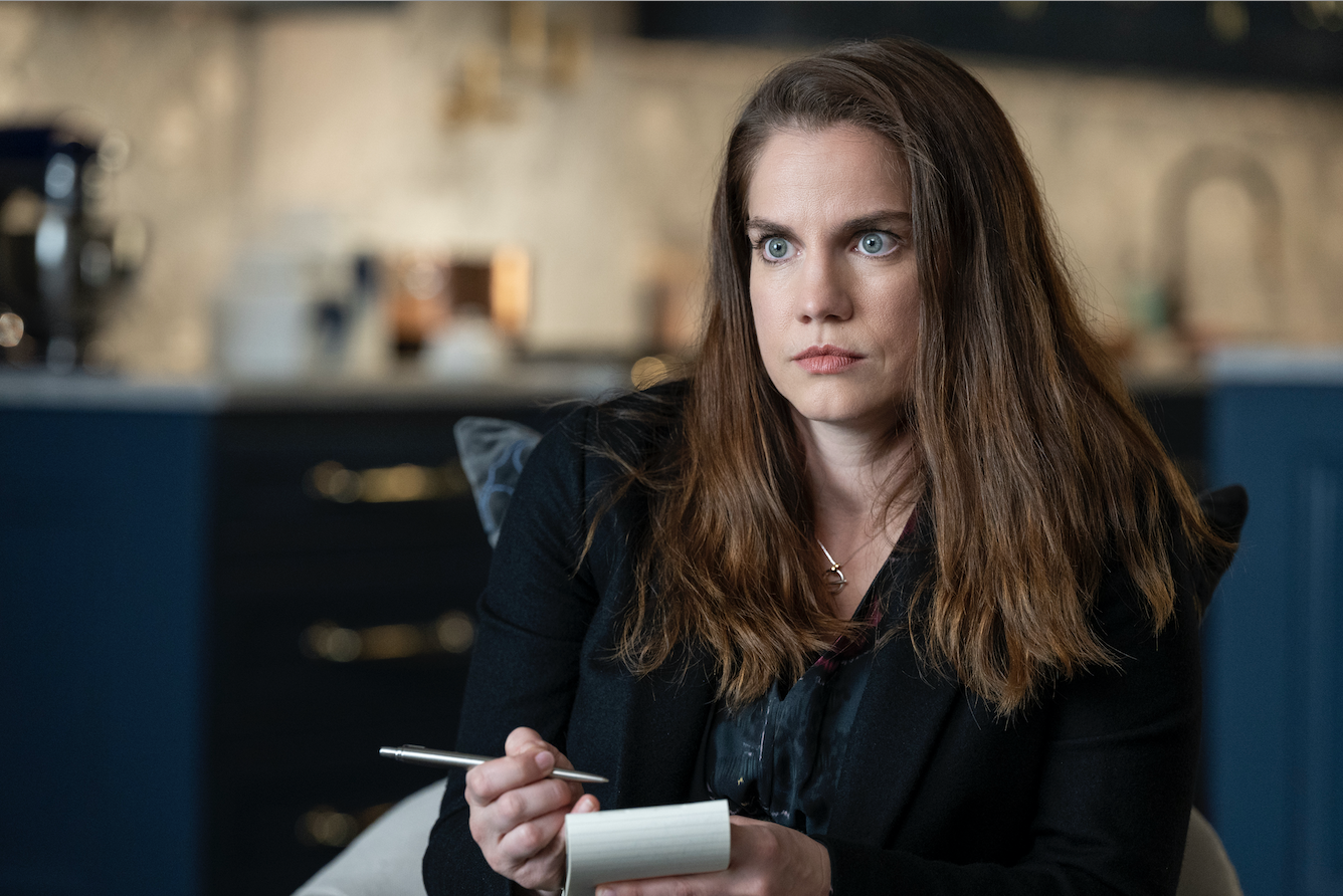 A journalist with her pen and notebook out