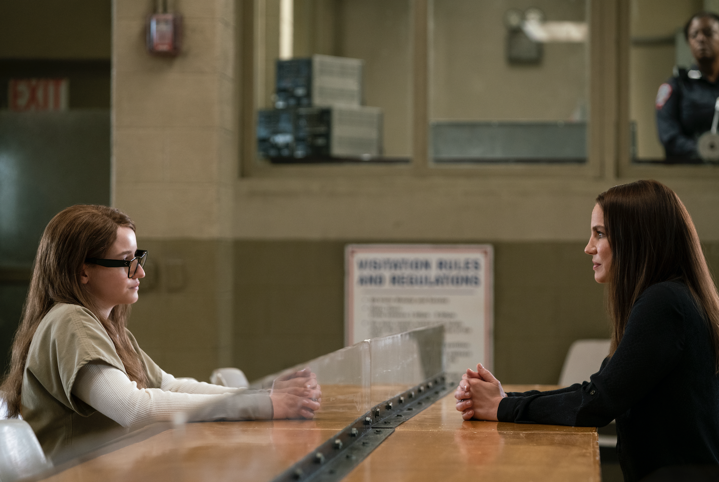 Two women having a conversation in prison