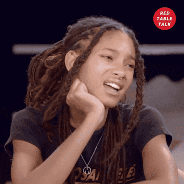 Willow Smith squints her eyes and waves her hand in &quot;Red Table Talk&quot;