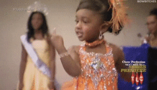 A contestant holds her middle finger up as she spins in &quot;Toddlers and Tiaras&quot;