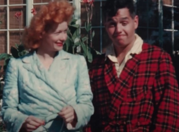 Lucy and Desi stand in the sun in their bathrobes in a home video