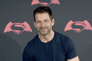 Director Zack Snyder with a banner for "Batman v Superman: Dawn of Justice" behind him