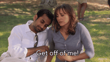Ann pushing Tom off of her on a picnic blanket on "Parks &amp; Rec"