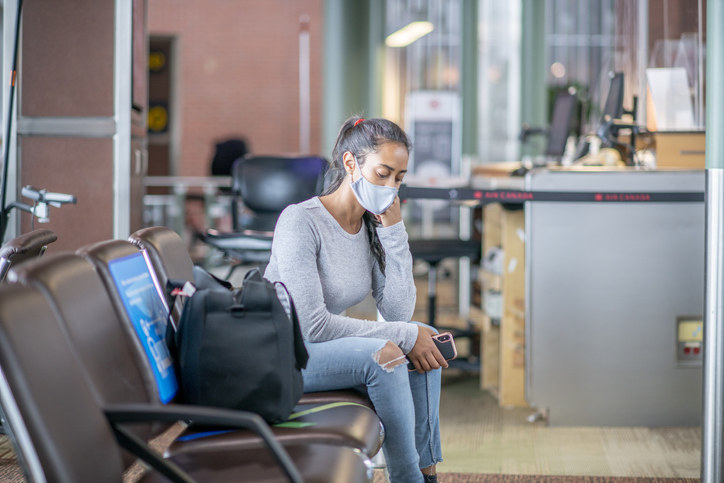 Middle Eastern person waiting for a flight