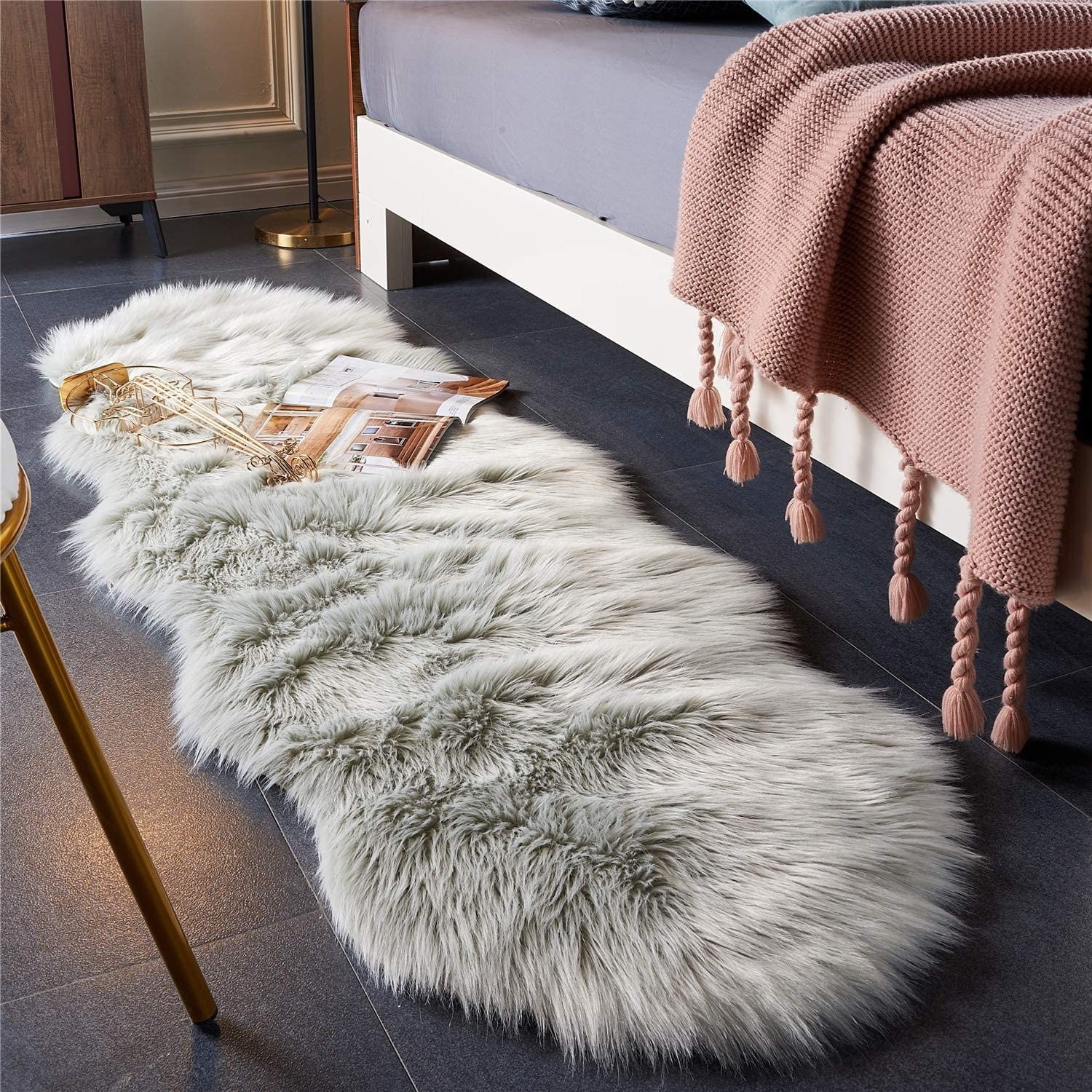 faux fur rug beside a bed