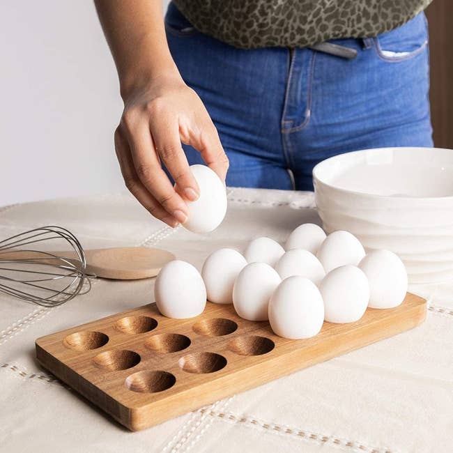 wooden egg holder with eggs inside