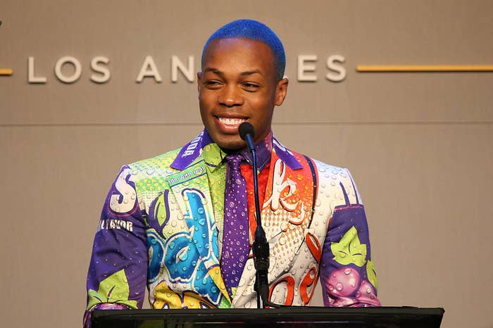 Todrick speaking behind a podium