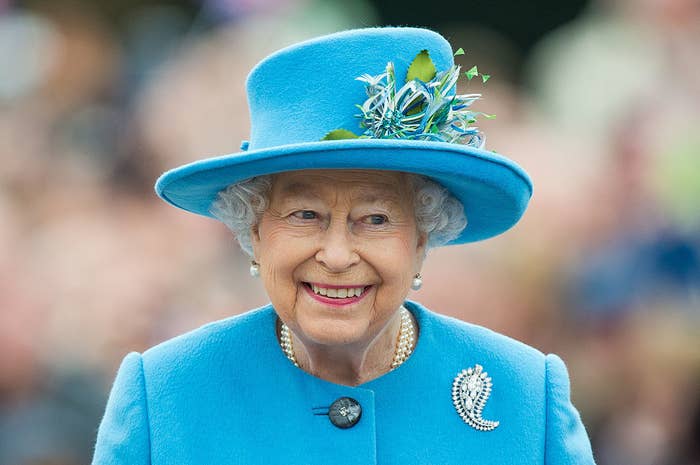 A smiling Queen Elizabeth in 2016, wearing a matching hat and coat