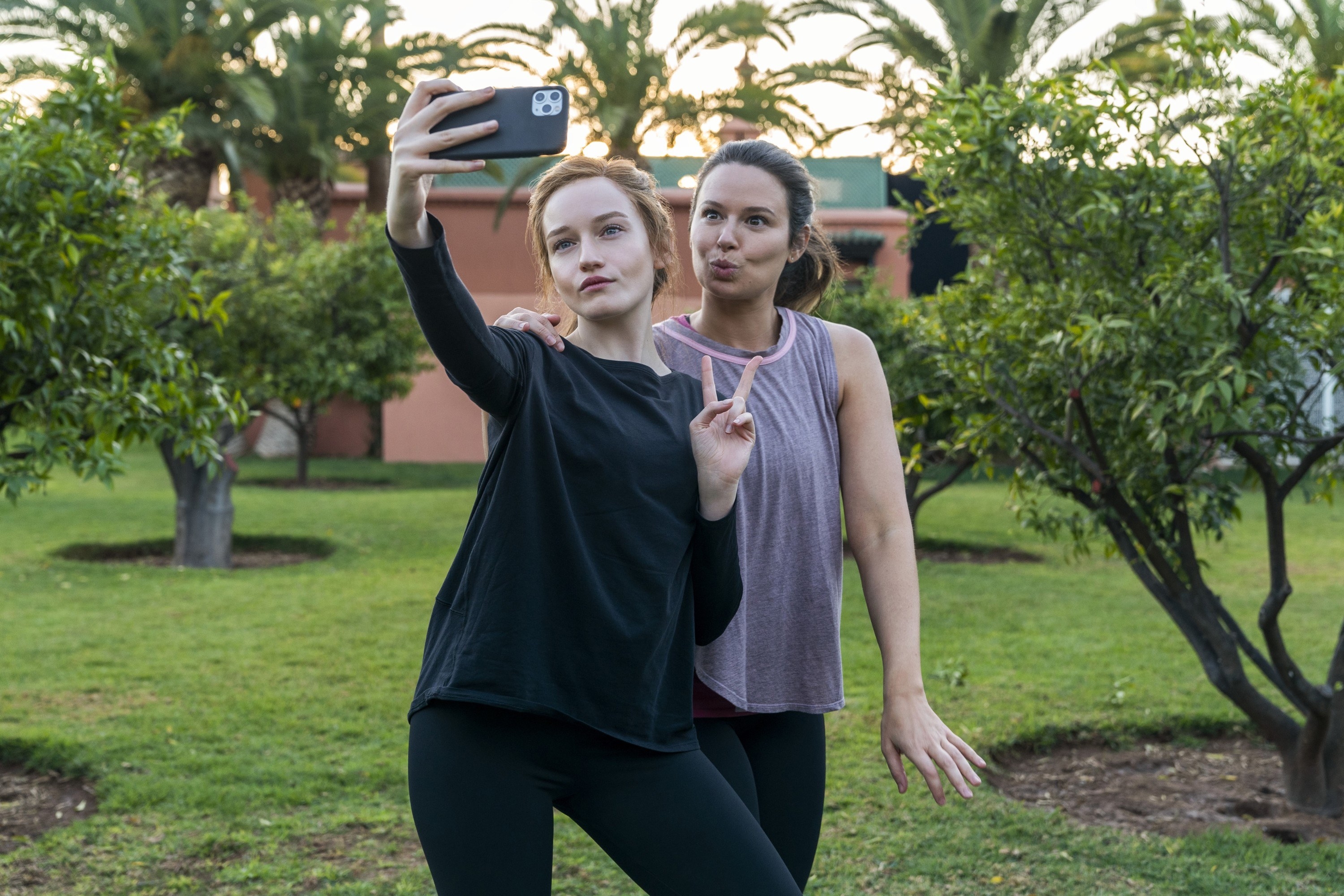 Rachel and Anna&#x27;s characters taking a selfie outside