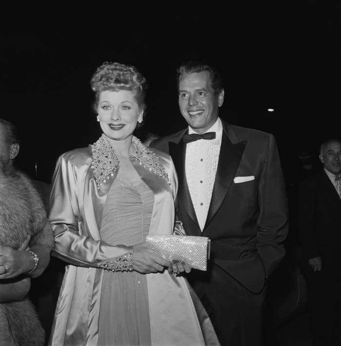 Lucille Ball and Desi Arnaz smile at an event in 1955