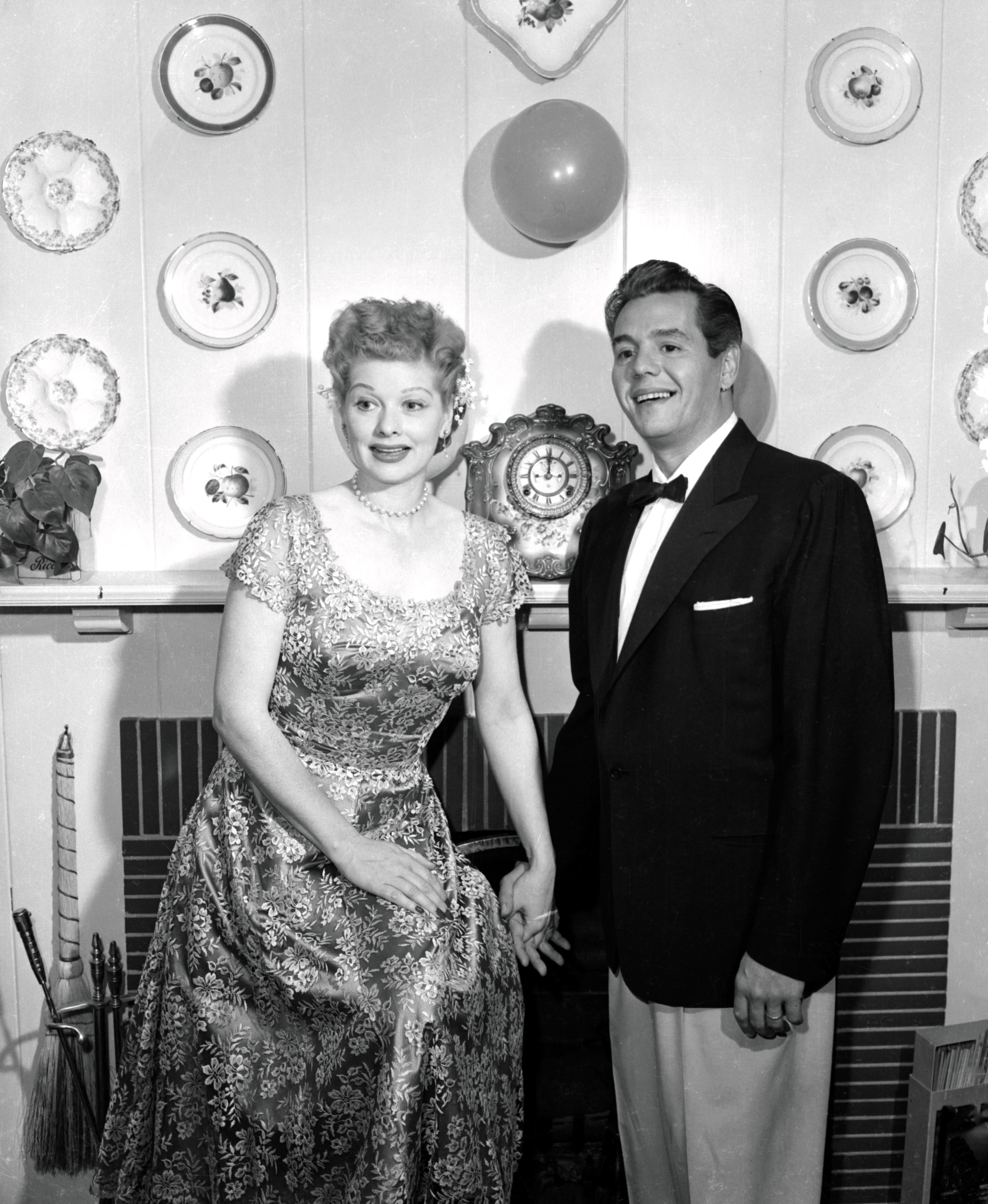 Lucille Ball and Desi Arnaz pose in their home for a promotional photo