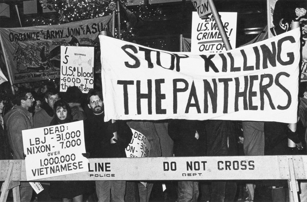 a sign says &quot;stop killing the panthers&quot;