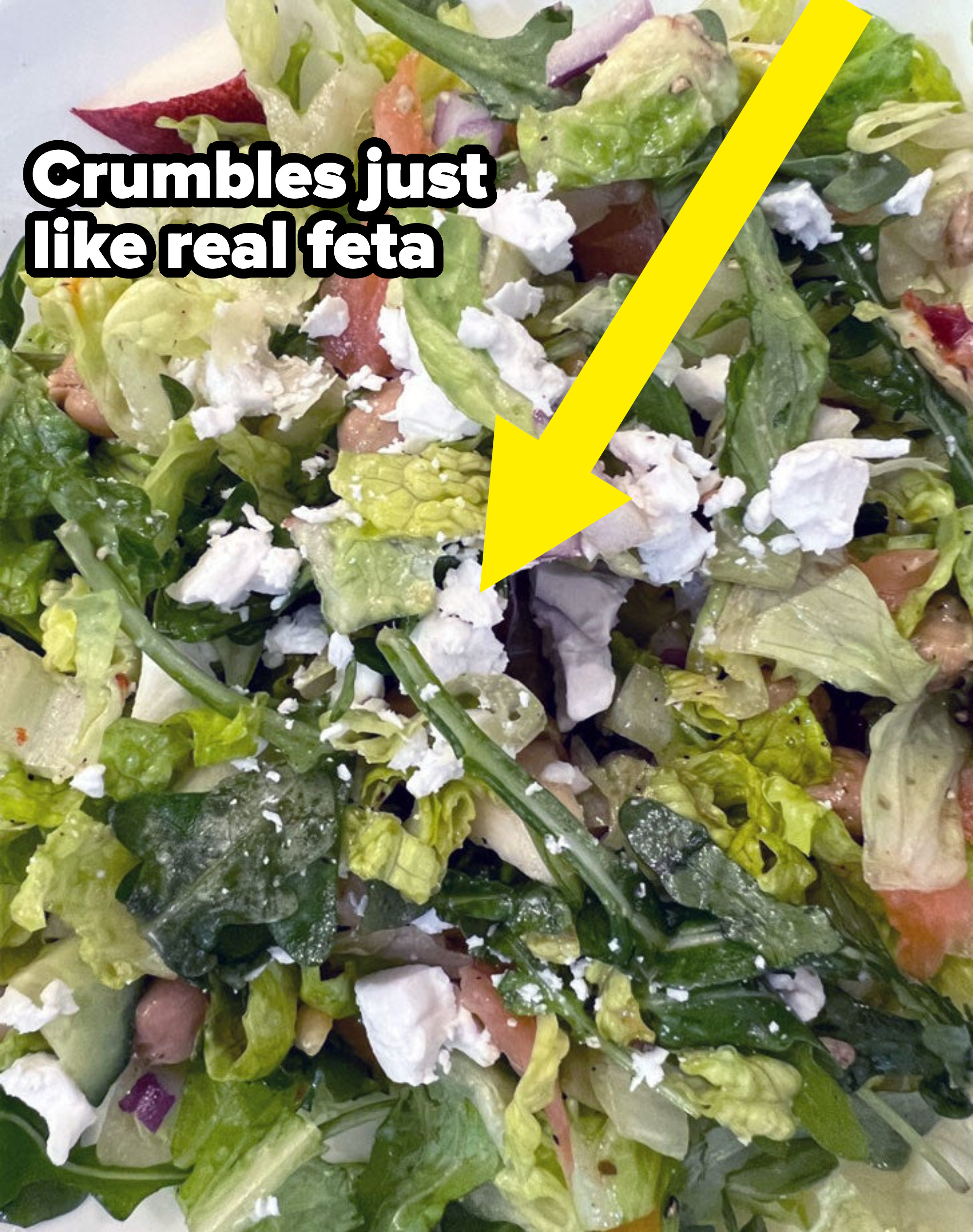 A salad with crumbled feta cheese.