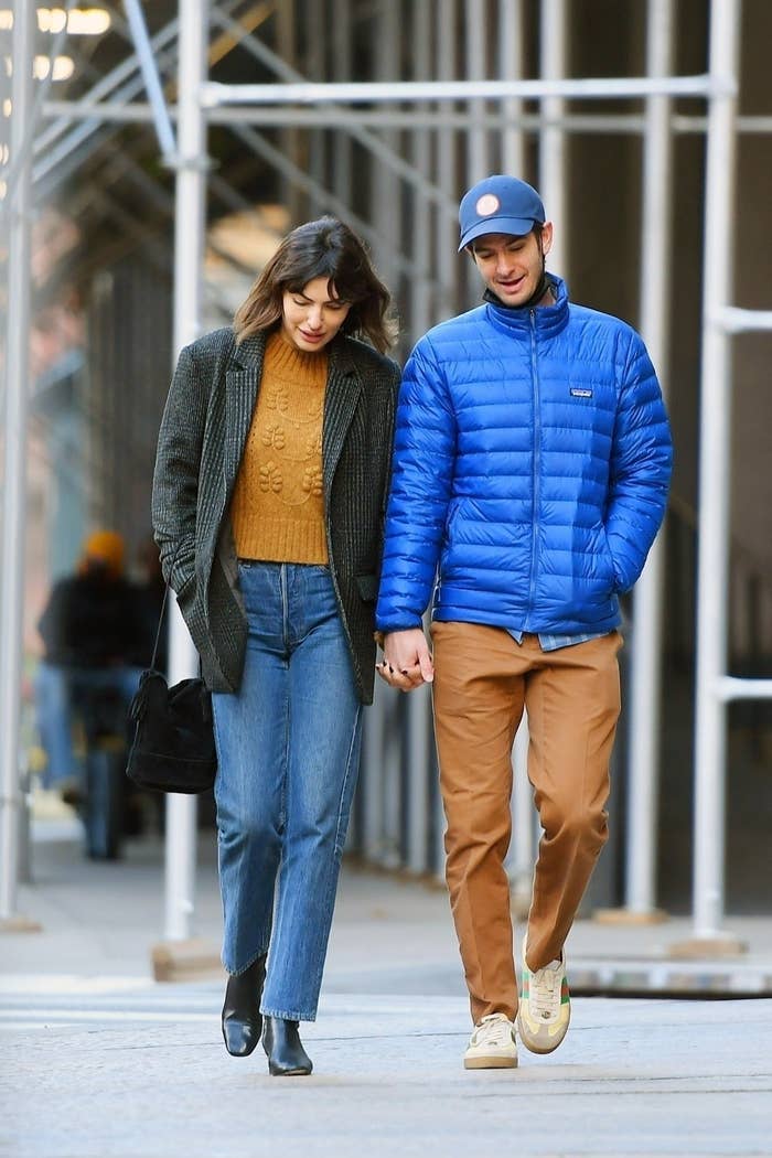 dressed in cozy, casual outfits, they walk hand-in-hand in Soho